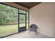 Relaxing screened porch with natural light and views of the surrounding greenery at 115 Court Xing, Locust Grove, GA 30248