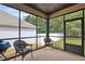 Cozy screened porch with comfortable seating, offering a relaxing outdoor space at 115 Court Xing, Locust Grove, GA 30248