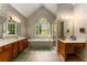Bright bathroom with a floral wallpaper, double sink vanity, bathtub, and large windows at 1950 Wenlok Ne Trl, Marietta, GA 30066