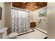 Classic bathroom with tile floor, shower with patterned curtain, and wood vanity at 1950 Wenlok Ne Trl, Marietta, GA 30066