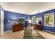 Bright bedroom with blue walls, desk and artwork, illuminated by natural light at 1950 Wenlok Ne Trl, Marietta, GA 30066