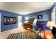 A cozy bedroom with blue walls, dresser, and artwork, lit by two windows at 1950 Wenlok Ne Trl, Marietta, GA 30066