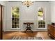 Dining room showcasing hardwood floors, classic chandelier, and natural light from large windows at 1950 Wenlok Ne Trl, Marietta, GA 30066