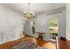 Elegant dining room with hardwood floors, chandelier, and wainscoting at 1950 Wenlok Ne Trl, Marietta, GA 30066