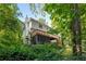 Exterior shot of the back of the home showcasing a spacious deck and lush landscaping, great for outdoor enjoyment at 1950 Wenlok Ne Trl, Marietta, GA 30066