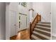 Bright foyer featuring hardwood floors, a staircase, and a transom window above the front door at 1950 Wenlok Ne Trl, Marietta, GA 30066
