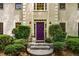 Close-up of a home's entrance with a distinctive purple door and manicured bushes at 1950 Wenlok Ne Trl, Marietta, GA 30066