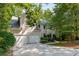 Lovely stucco home with a two-car garage, inviting entrance, and mature trees at 1950 Wenlok Ne Trl, Marietta, GA 30066