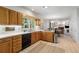 Spacious kitchen with wooden cabinets and stainless steel appliances overlooking the dining and living areas at 1950 Wenlok Ne Trl, Marietta, GA 30066