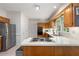 Well-lit kitchen with wood cabinets, stainless steel appliances, and tiled flooring at 1950 Wenlok Ne Trl, Marietta, GA 30066