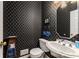 Unique powder room featuring patterned wallpaper, a pedestal sink, and decorative accents at 1950 Wenlok Ne Trl, Marietta, GA 30066