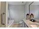 Modern bathroom with granite countertops, framed mirror, and bathtub with tile surround at 2220 Lily Valley Dr, Lawrenceville, GA 30045
