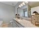 Well-lit bathroom with granite counters, framed mirror, bathtub, and modern vanity at 2220 Lily Valley Dr, Lawrenceville, GA 30045