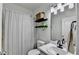 Cozy bathroom featuring a shower and bathtub combination with minimalist decor and ample lighting at 2220 Lily Valley Dr, Lawrenceville, GA 30045