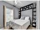Comfortable bedroom featuring modern built-in shelving and ample natural light from the window at 2220 Lily Valley Dr, Lawrenceville, GA 30045