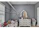 Cute bedroom boasting a distinctive bed frame and a white dresser with ornate details at 2220 Lily Valley Dr, Lawrenceville, GA 30045
