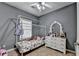 Charming bedroom featuring a unique canopy bed frame and a dresser with a decorative mirror at 2220 Lily Valley Dr, Lawrenceville, GA 30045