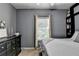 Bright bedroom with a window view, complemented by a black dresser and stylish decor at 2220 Lily Valley Dr, Lawrenceville, GA 30045