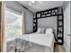Comfortable bedroom featuring modern built-in shelving and ample natural light from the window at 2220 Lily Valley Dr, Lawrenceville, GA 30045
