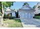 Charming single-story home with a well-manicured lawn and a two-car garage in a suburban neighborhood at 2220 Lily Valley Dr, Lawrenceville, GA 30045