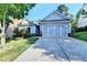 Charming single-story home with a well-manicured lawn and a two-car garage in a suburban neighborhood at 2220 Lily Valley Dr, Lawrenceville, GA 30045