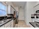 Well-lit kitchen features stainless steel appliances, granite countertops, and decorative backsplash at 2220 Lily Valley Dr, Lawrenceville, GA 30045