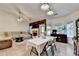 Inviting living area with a vaulted ceiling, fan, fireplace, and a dining table near the windows at 2220 Lily Valley Dr, Lawrenceville, GA 30045
