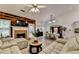 Open-concept living room with a fireplace, plenty of seating, and a dining area with a hutch at 2220 Lily Valley Dr, Lawrenceville, GA 30045