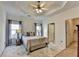 Serene main bedroom boasts a tray ceiling, ceiling fan, and ensuite bathroom access at 2220 Lily Valley Dr, Lawrenceville, GA 30045
