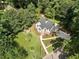An aerial view of a lovely home with a lush yard, charming landscaping and a long driveway at 2249 Beecher Sw Rd, Atlanta, GA 30311