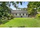 A well-maintained backyard features lush green grass, mature trees, and a charming patio area at 2249 Beecher Sw Rd, Atlanta, GA 30311
