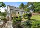 Charming backyard with mature landscaping, a stone walkway, and an inviting deck at 2249 Beecher Sw Rd, Atlanta, GA 30311