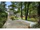 A home's backyard features green grass, mature trees, and a large concrete patio at 2249 Beecher Sw Rd, Atlanta, GA 30311