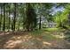 A lovely backyard featuring mature trees and a spacious lawn at 2249 Beecher Sw Rd, Atlanta, GA 30311