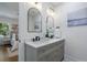 Modern bathroom features double vanity with neutral paint, and an open door to the main bedroom at 2249 Beecher Sw Rd, Atlanta, GA 30311