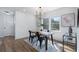 Sunlit dining room featuring a wooden table, black chairs, and stylish decor at 2249 Beecher Sw Rd, Atlanta, GA 30311