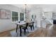 A modern dining room with a stylish chandelier and a view of the backyard at 2249 Beecher Sw Rd, Atlanta, GA 30311