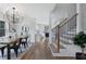 Open-concept dining area leading to the kitchen and stairway at 2249 Beecher Sw Rd, Atlanta, GA 30311