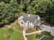 Charming cottage-style home with stone accents, nestled among lush trees and manicured landscaping at 2249 Beecher Sw Rd, Atlanta, GA 30311