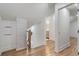 Hallway with hardwood floors and white brick accent wall at 2249 Beecher Sw Rd, Atlanta, GA 30311