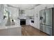 Modern kitchen with white cabinetry, stainless steel appliances, and hardwood floors at 2249 Beecher Sw Rd, Atlanta, GA 30311