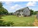 Spacious backyard, complete with a patio set, lush lawn, and a charming wooden fence at 4275 Hunters Walk Way, Cumming, GA 30028