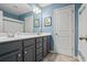 Bright bathroom with blue walls and a double sink vanity at 4275 Hunters Walk Way, Cumming, GA 30028
