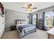 Bedroom with grey walls, ceiling fan, and backyard view at 4275 Hunters Walk Way, Cumming, GA 30028