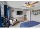 Comfortable bedroom with carpet flooring, ceiling fan and a wall-mounted tv above a chest of drawers at 4275 Hunters Walk Way, Cumming, GA 30028
