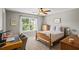 Cozy bedroom with neutral colors and a large window overlooking the backyard at 4275 Hunters Walk Way, Cumming, GA 30028