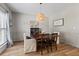 Dining room with a stylish light fixture, wood floors, a dining table with seating, and wainscoting at 4275 Hunters Walk Way, Cumming, GA 30028