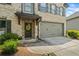 Close-up of a beautifully maintained home showcasing a two-car garage and a decorated front entrance at 4275 Hunters Walk Way, Cumming, GA 30028