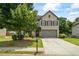 Charming two-story home featuring a well-manicured lawn, a brick facade, and a welcoming front porch at 4275 Hunters Walk Way, Cumming, GA 30028