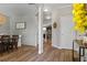 Spacious hallway with light wood floors, neutral walls, and views of the adjacent dining room and kitchen at 4275 Hunters Walk Way, Cumming, GA 30028